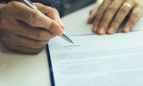 Preview: Close up hand man signing paper contract agreement for buying house.