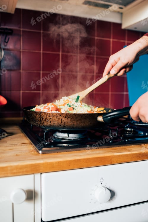 Preview: Close up on the hand of a man blending rice and vegetables