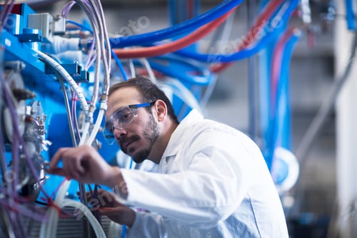 Preview: Scientist adjusting heavy machinery