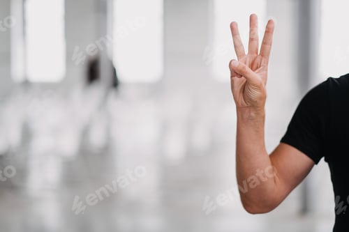 Preview: Selective focus shot of a person holding up three fingers