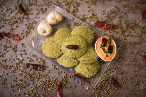 Preview: Green idly,south indian famous breakfast served with two chutneys closeup with selective focus