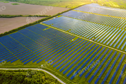 Preview: Aerial view of large sustainable electrical power plant with many rows of solar photovoltaic panels