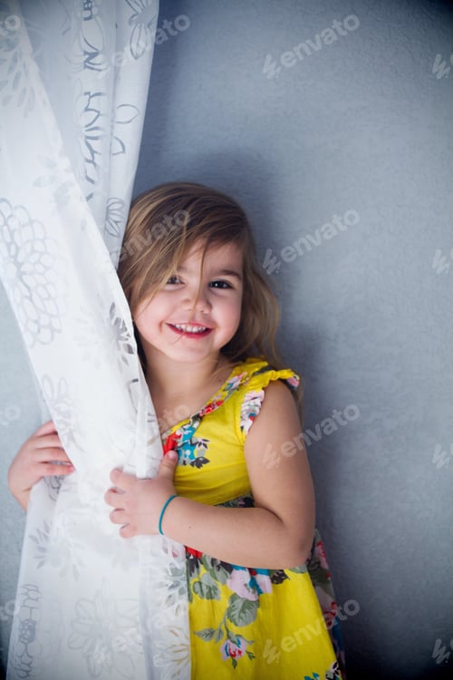 Preview: Little girl hiding behind curtain