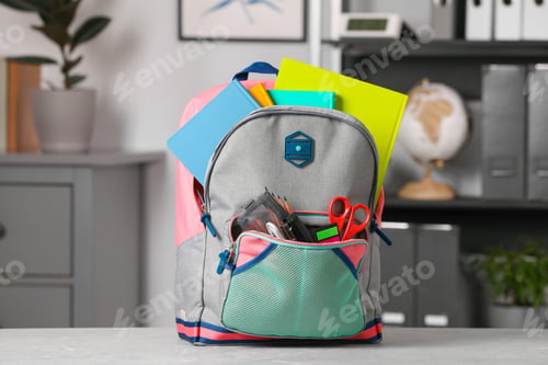 Preview: Children's backpack with different school stationery on table indoors