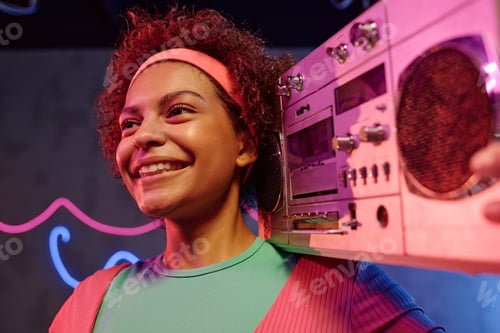 Preview: Cheerful Woman Holding Vintage Music Device