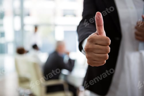 Preview: Businesswoman showing thumbs up