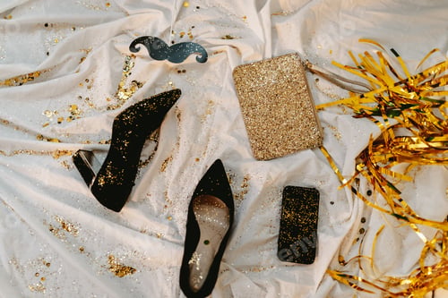 Preview: Celebrating New Years Eve. Glitter sparkling confetti. Cocktail party night. Having fun. Heels,purse