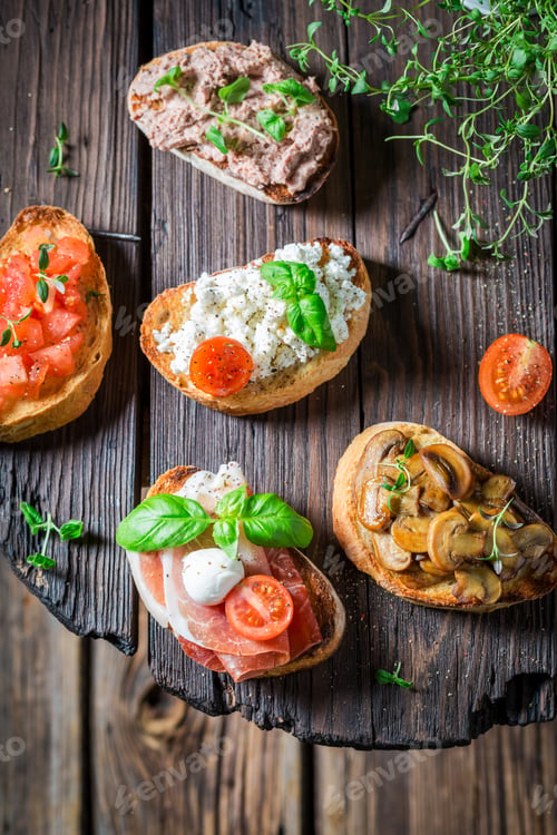 Preview: Crisp and hot various bruschetta with fresh ingredients for breakfast.