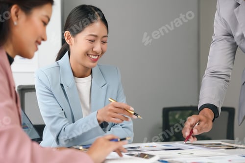 Preview: Business team meeting in office, analyzing sales data, planning marketing strategies.