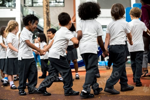 Preview: Group of diverse kindergarten students standing holding hands to
