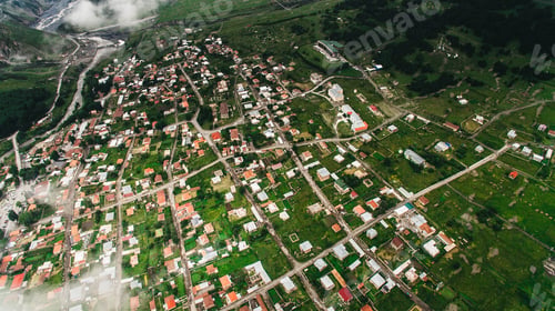 Preview: aerial view of city in green mountains with clouds, Georgia