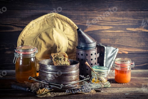 Preview: Vintage beekeeper tools on old wooden table