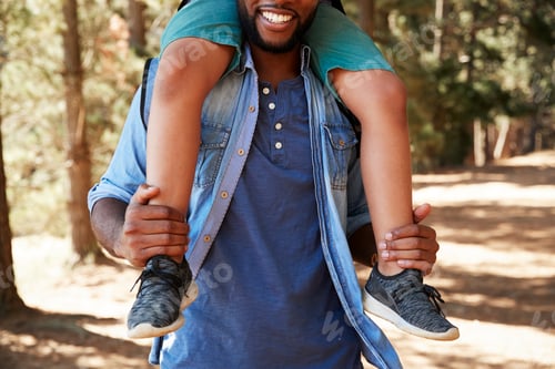 Preview: Close Up Of Father Walking In Woods Carrying Son On Shoulders