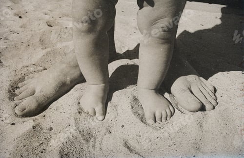 Preview: Legs (feet) of father and son on sandy beach