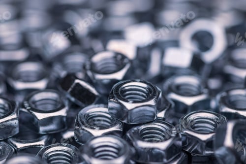 Preview: Metal chrome nuts in a chaotic order industrial background