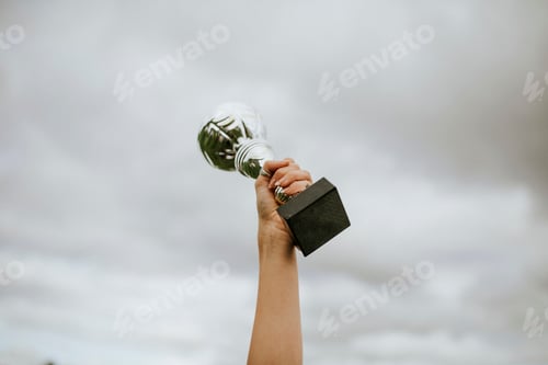 Preview: Human hand holding a trophy cup