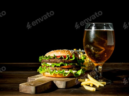 Preview: Burger with beer in a glass and fries.