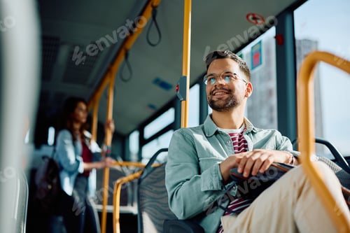 Preview: Below view of happy man commuting by public transport.
