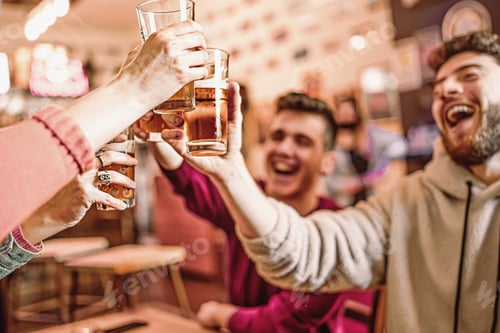 Preview: Happy friends at pub cafe raising beer glasses