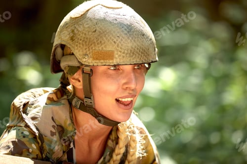 Preview: Caucasian Military lady woman in tactical gear posing for photo at summer season. Wearing green camo