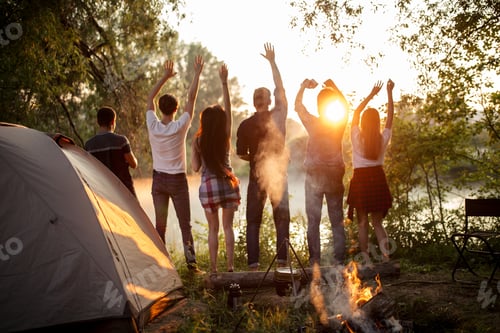 Preview: young cheerful tourists admires with gorgeous sunset