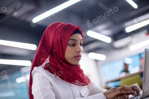 Preview: black muslim business woman ,working on laptop computer