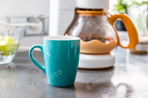 Preview: One ceramic cup with a hot drink on the table on the kitchen