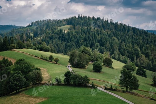 Preview: Road in mountain valley at sunny morning in Poland.