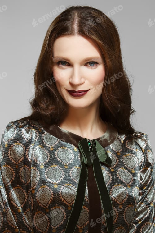 Preview: Attractive lady with dark long curly hair, clean fresh skin. Blue eyes and dark red mat lips.