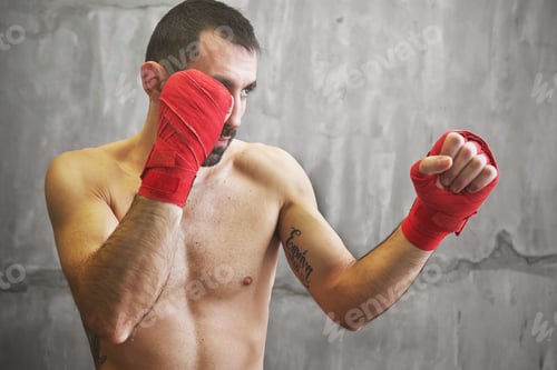 Preview: Shot of wrapped hands with red boxing tape of young boxer fight