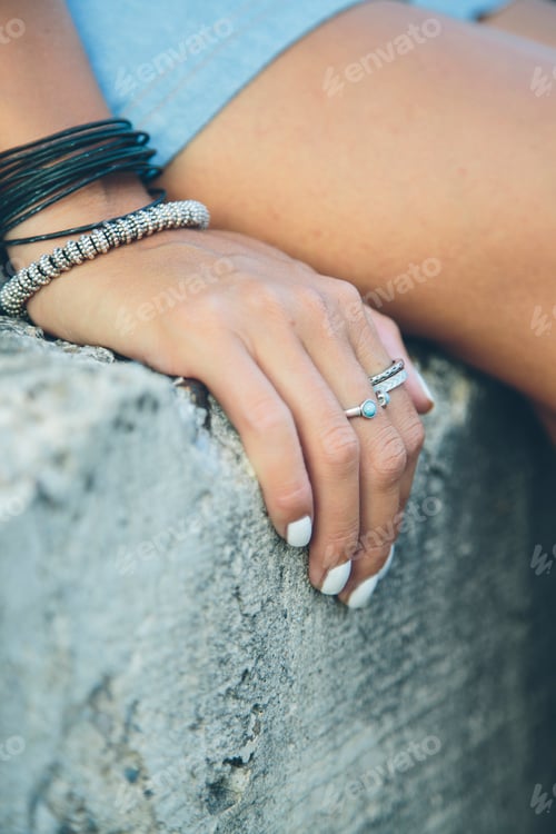 Preview: Woman sitting on stone wall