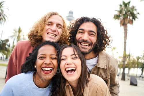 Preview: Group of four multi-ethnic young friends having fun. Smiling cheerful people looking at the camera