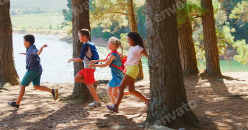 Preview: Group Of Children Running Along Trail By Lake On Hiking Adventure In Countryside