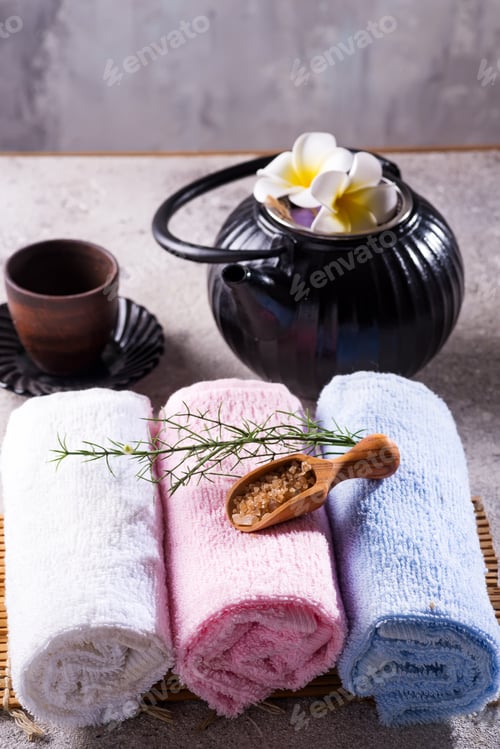 Preview: Color towels with green leaves, spoon of salt and detox tea on bamboo mat and stone table