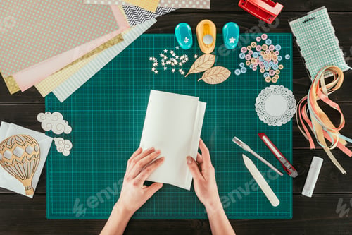 Preview: cropped image of artist holding template for scrapbooking handmade postcard