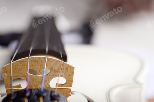 Preview: Close view of a violin on white wooden table