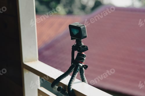 Preview: Action camera on tripod capturing time-lapsed video.
