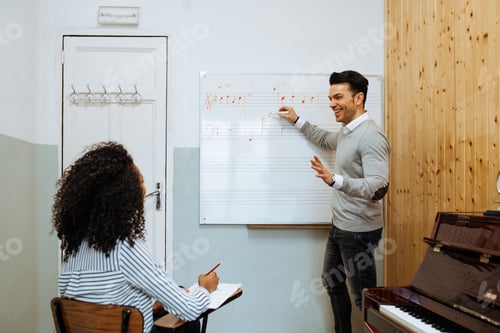 Preview: Man teaching woman music notes