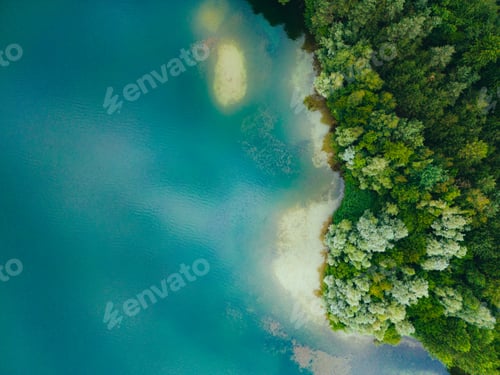 Preview: Aerial drone top down view of lake among forest with beautiful turquoise water in summer day.