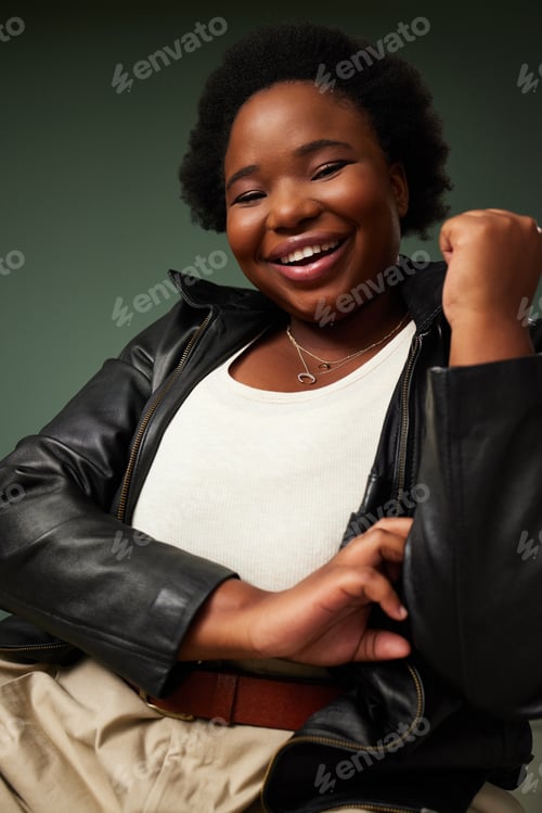 Preview: Studio shot of a beautiful young woman posing against a green background
