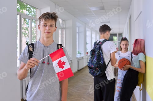 Preview: Student teenager male with flag of Canada inside school