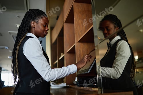 Preview: Young Adult Black Woman Restaurant Worker Using Digital Tablet at Counter