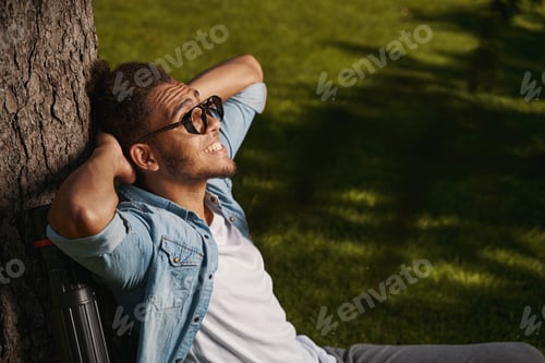 Preview: Mirthful person looking happy while being outdoors
