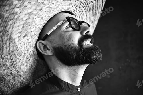 Preview: Hipster Guy In Glasses With A Gray Beard In A Hat With Brim. Emotionally Posing Model Man