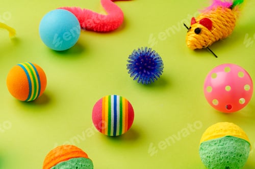 Preview: Colorful pet toys balls on green background