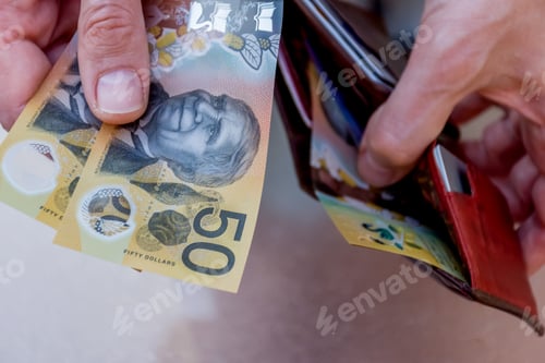 Preview: Hands holding wallet with australian dollars and make a payment - finance struggle concept.