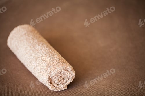 Preview: Towel on brown bed with copy space in living room.