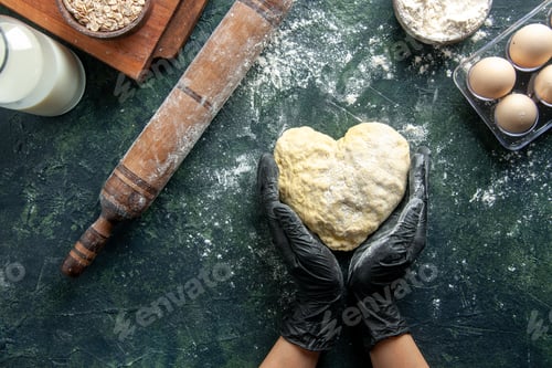 Preview: top view female cook working with heart shaped dough on dark gray background cake job oven hotcake