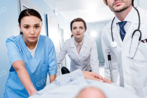Preview: Cropped view of doctors transporting patient together