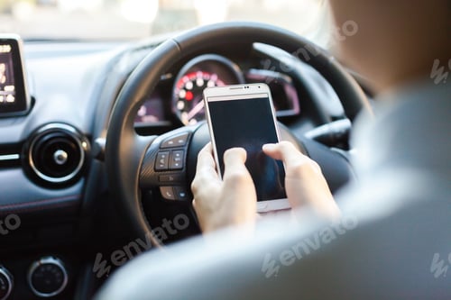 Preview: man using phone while driving the car (selective focus) - transportation and vehicle concept